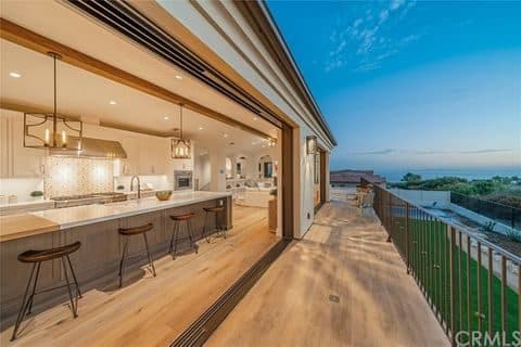 Remodeled kitchen opening to an ocean view deck